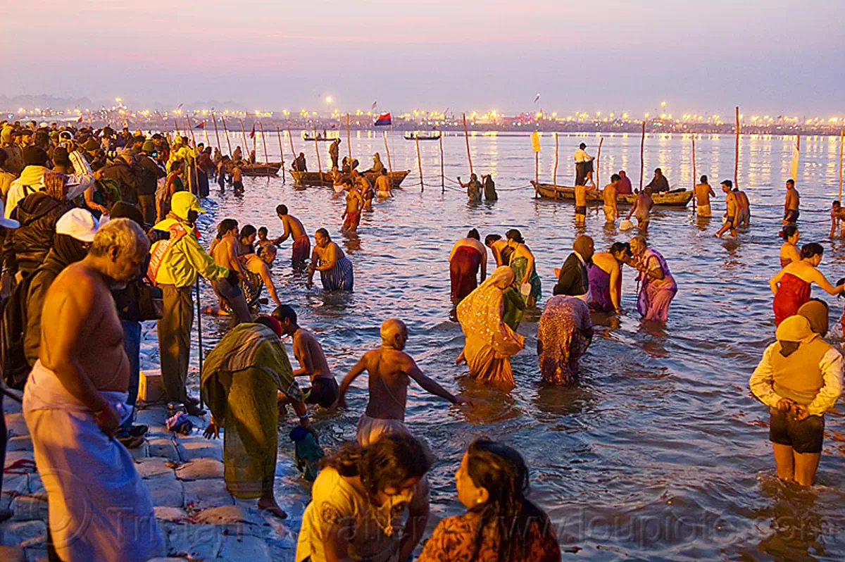 Hindu pilgrims bathing at Triveni Sangam